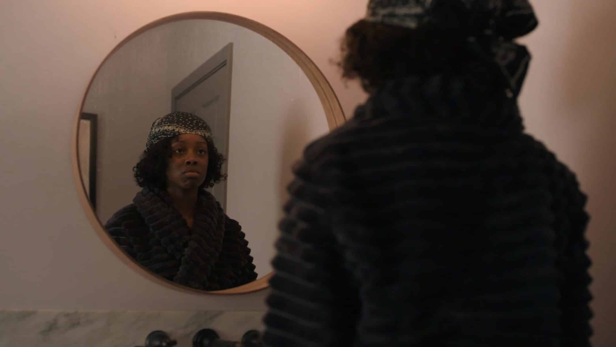 Kiesha looking into the mirror.