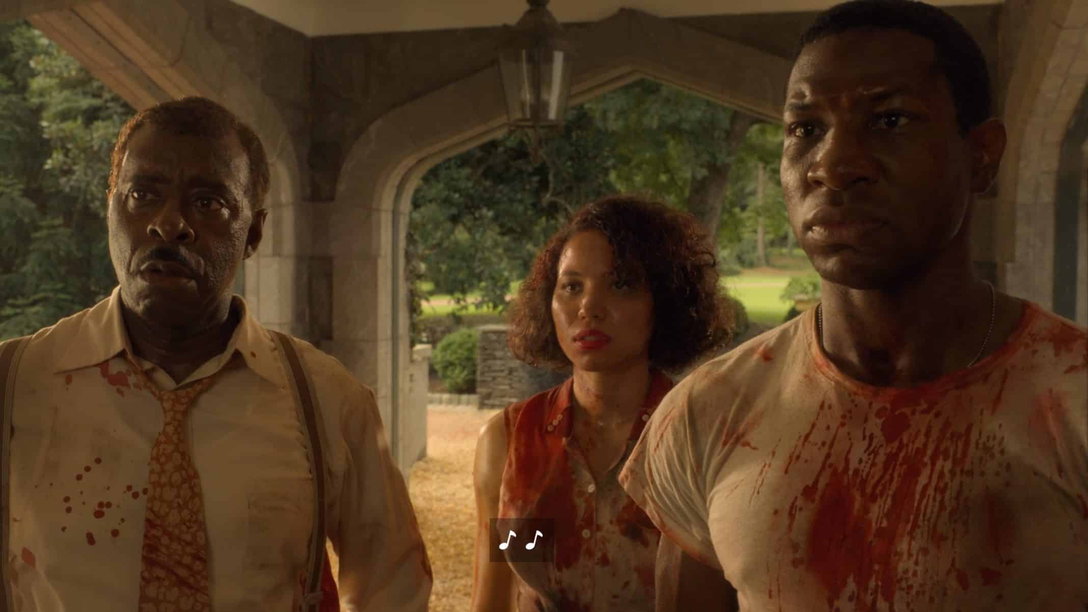 Uncle George (Courtney B. Vance), Letitia (Jurnee Smollett), and Atticus (Jonathan Majors) with blood on their clothes.