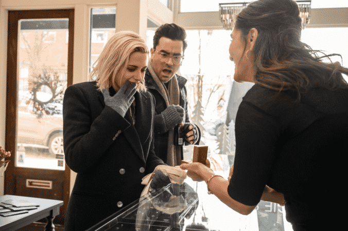 The Jeweler (SARAB KAMOO) shows Abby (KRISTEN STEWART) rings with John (DAN LEVY)