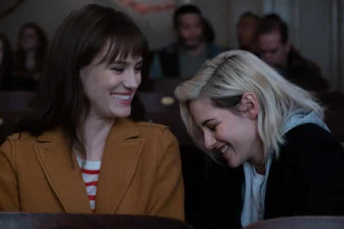 Abby (KRISTEN STEWART, right) and Harper (MACKENZIE DAVIS) enjoy a moment at the movies