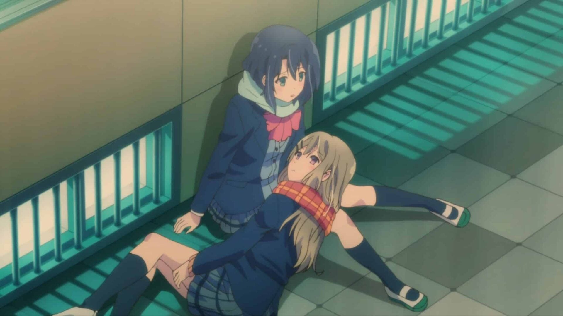 Shimamura laying on Adachi's lap.