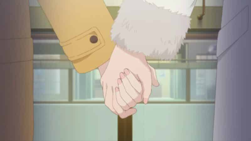 Adachi and Shimamura holding hands.