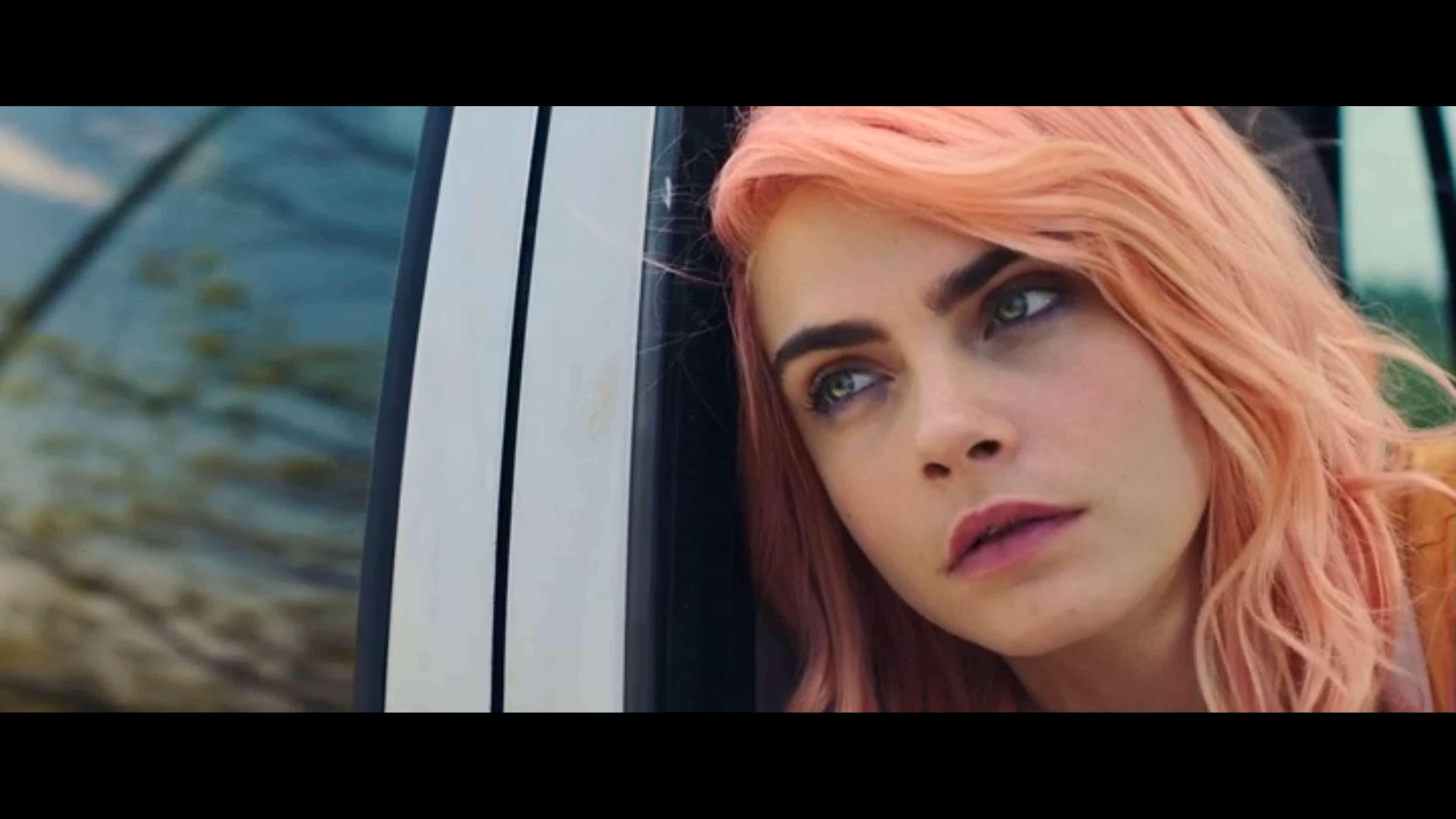 Isabelle (Cara Delevingne) looking out a window