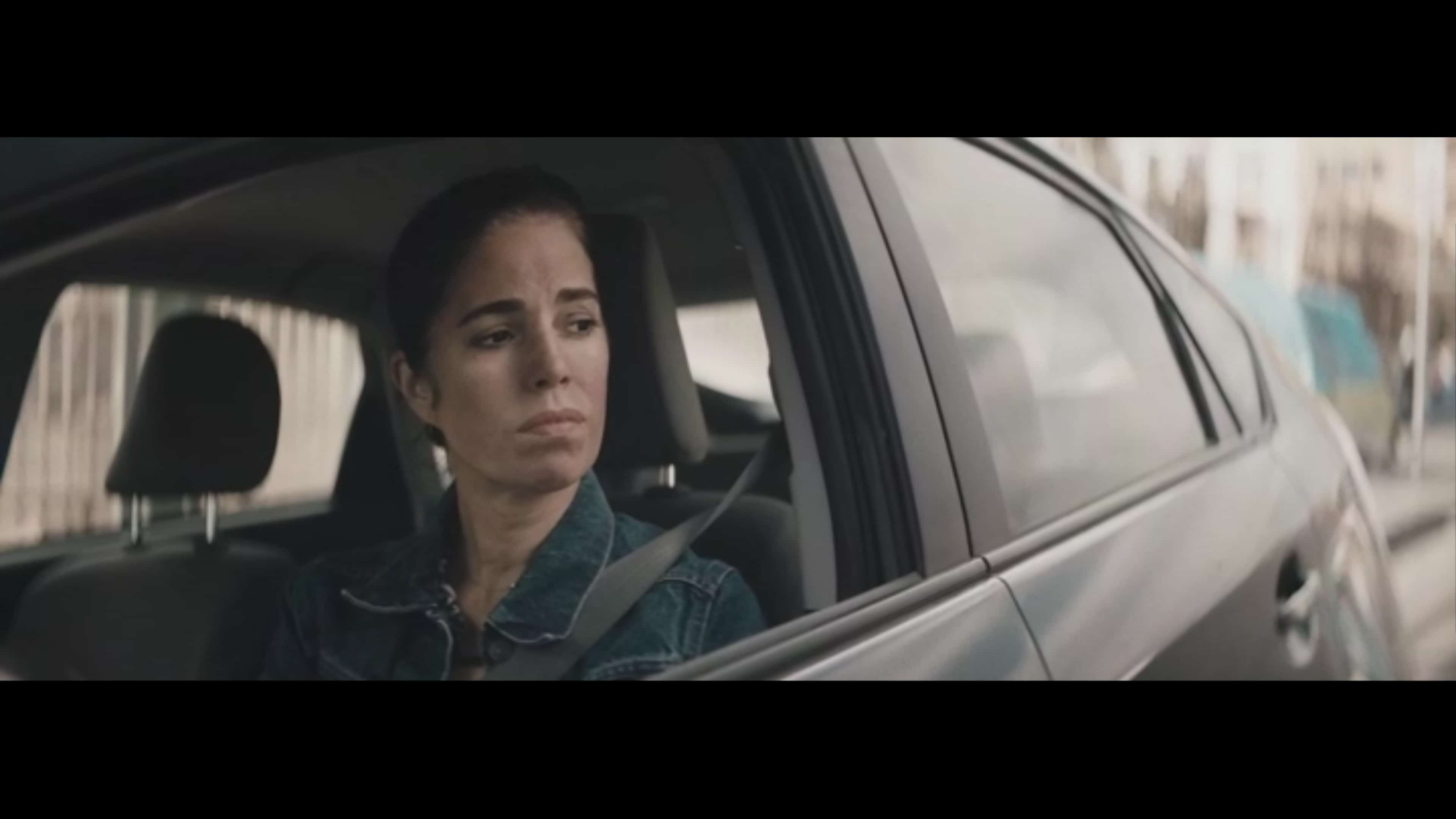 Ms. Rodriguez (Ana Ortiz) looking out the driver's side window.