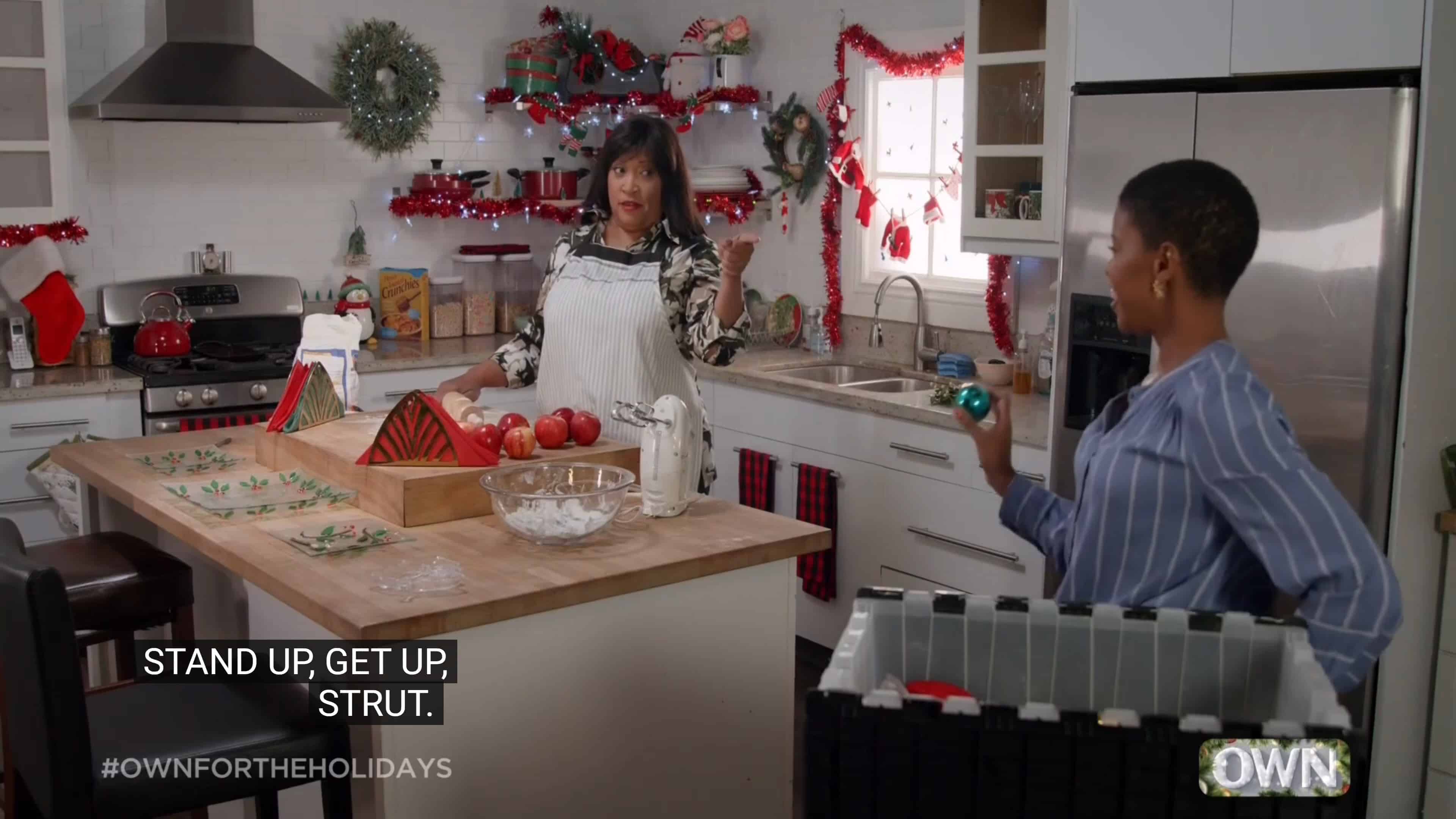 Debbie (Jackée Harry) and Lena (Morgan Dixon) talking in the kitchen