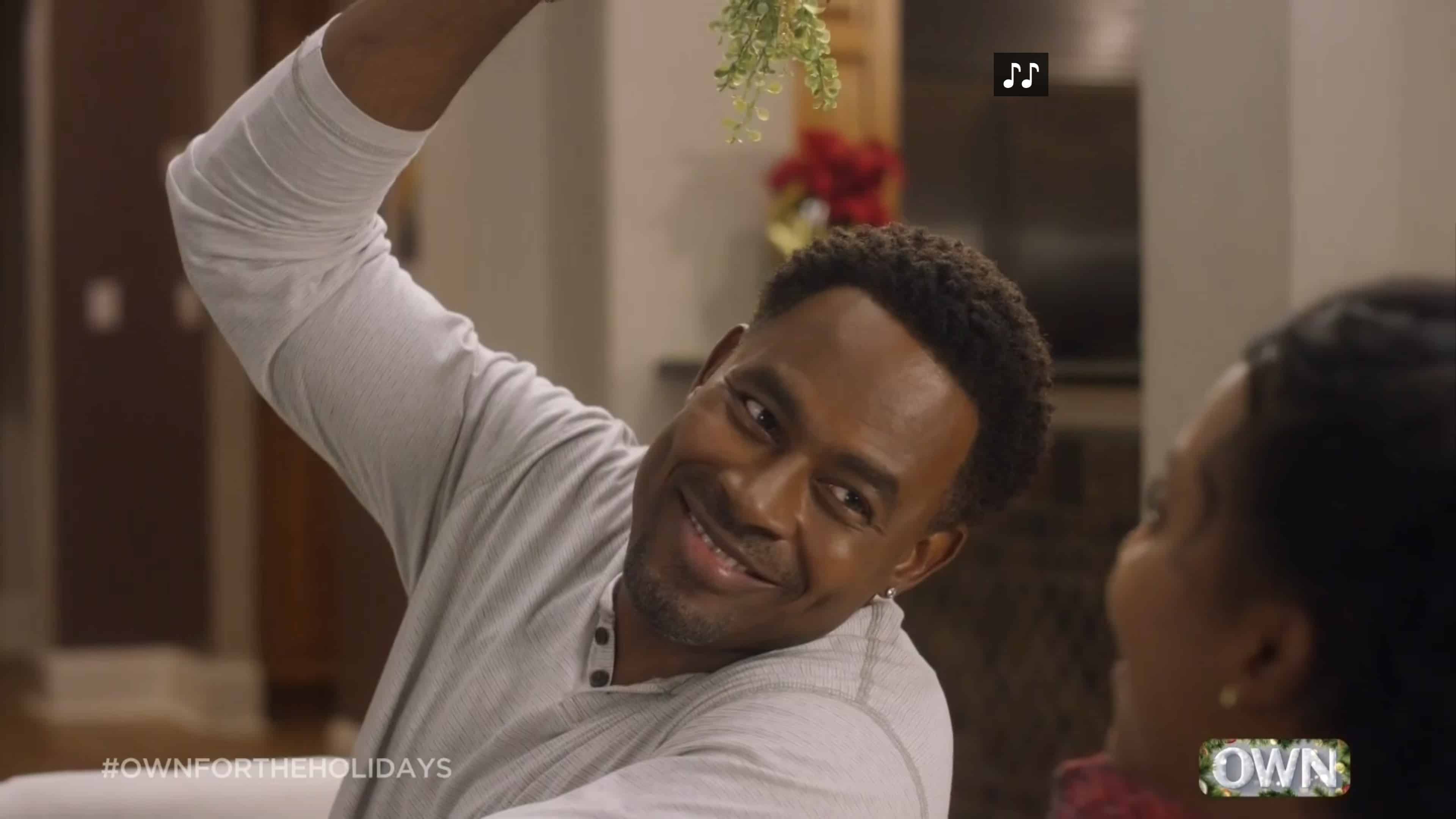 Donovan (Lamman Rucker) holding a mistletoe. 