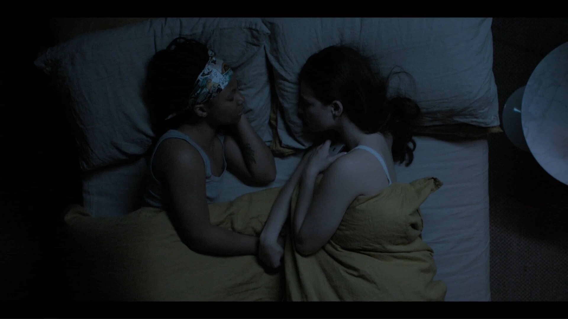 Harper and Yasmin sleeping in bed together.