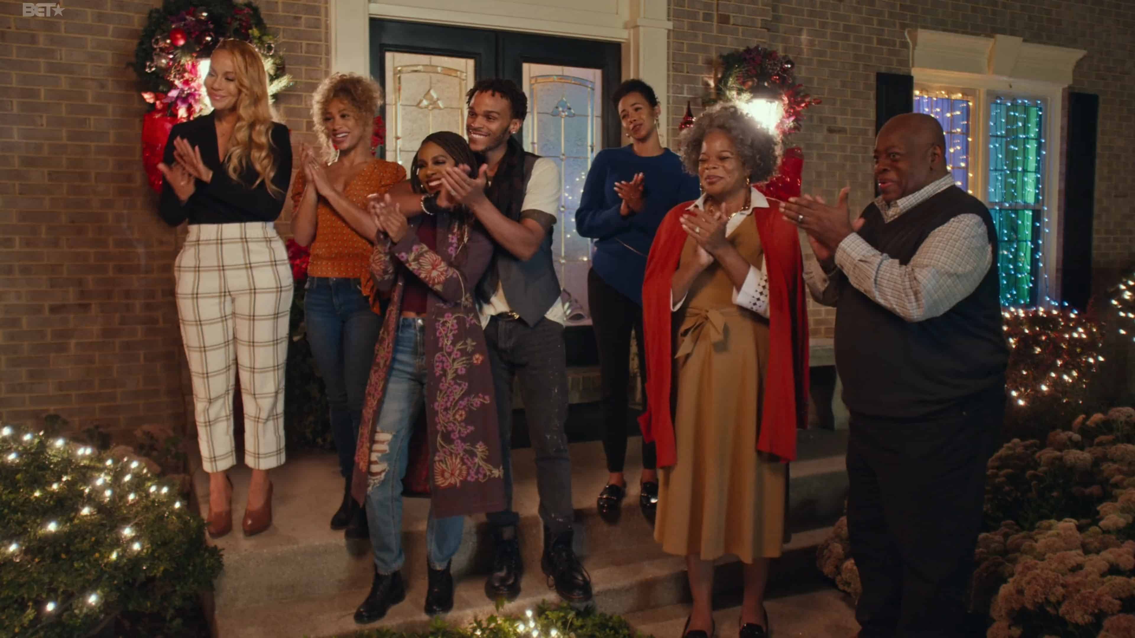 Nicole (Brave Williams), Diedre (Asia'h Epperson), Tammy (Candiace Bassett), Spyder (Terayle), Belinda (Phylicia Morgan), Diane (Kay-Megan Washington), and Gerald (Reginald VelJohnson) clapping for carolers 