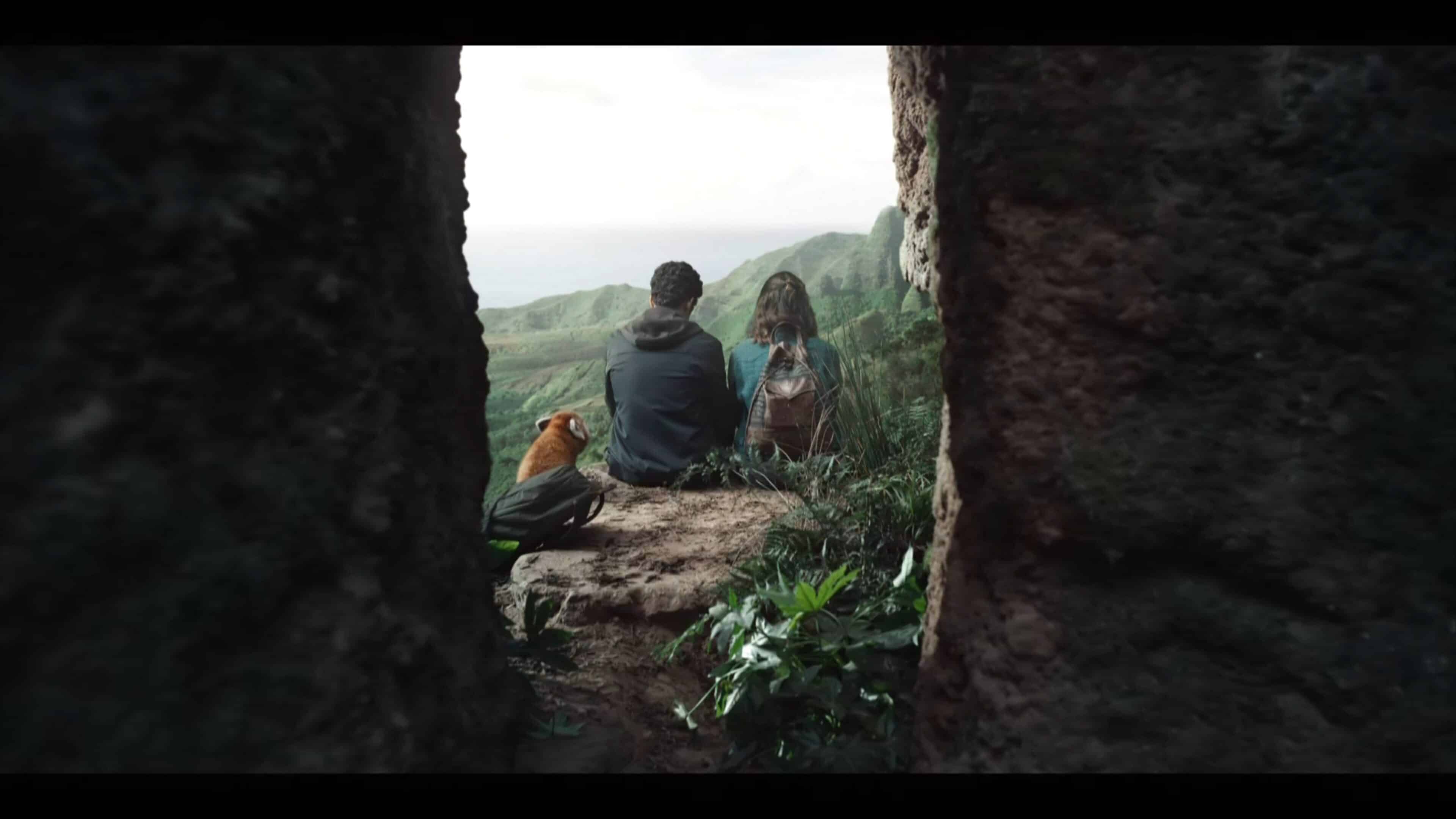 Pan, Will, and Lyra sitting on a cliff