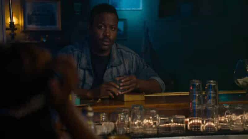 George (Kevin Daniels) sitting at a bar