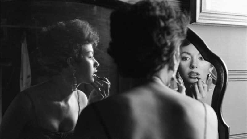 Rita Moreno Putting On Lipstick In Mirror, 1954