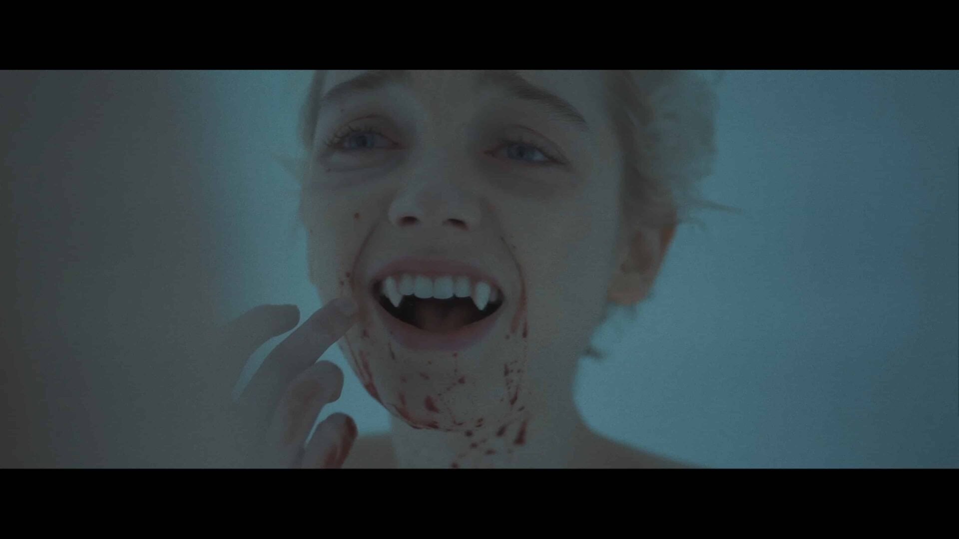 Sarah (Juliah Sarah Stone) discovering she has vampire fangs