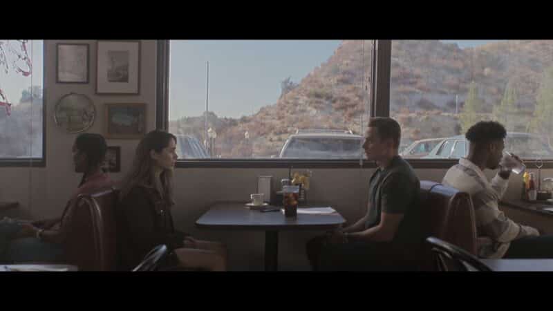 Hazel and Byron sitting at a diner together