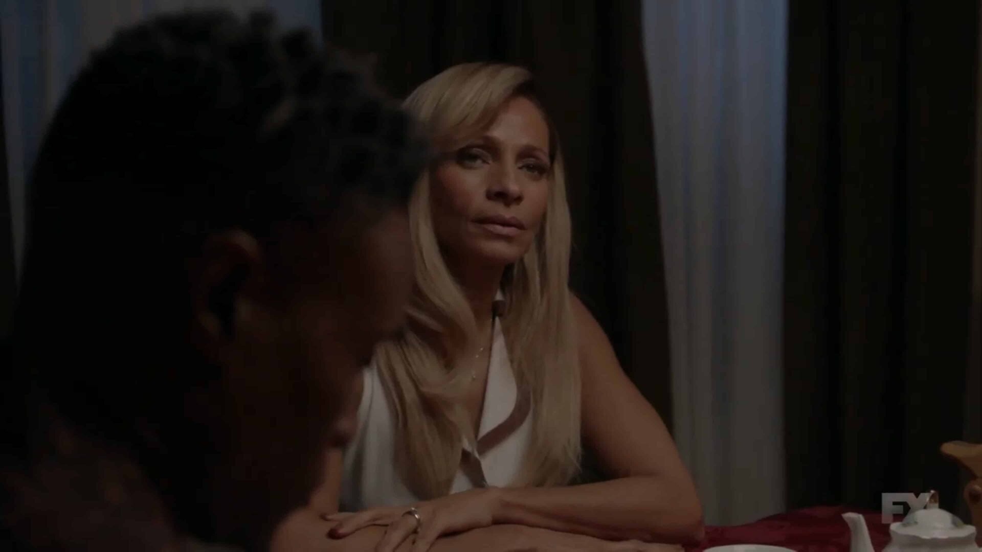 Ebony (Michelle Hurd) at dinner with her kids, husband and high school best friend Pray Tell