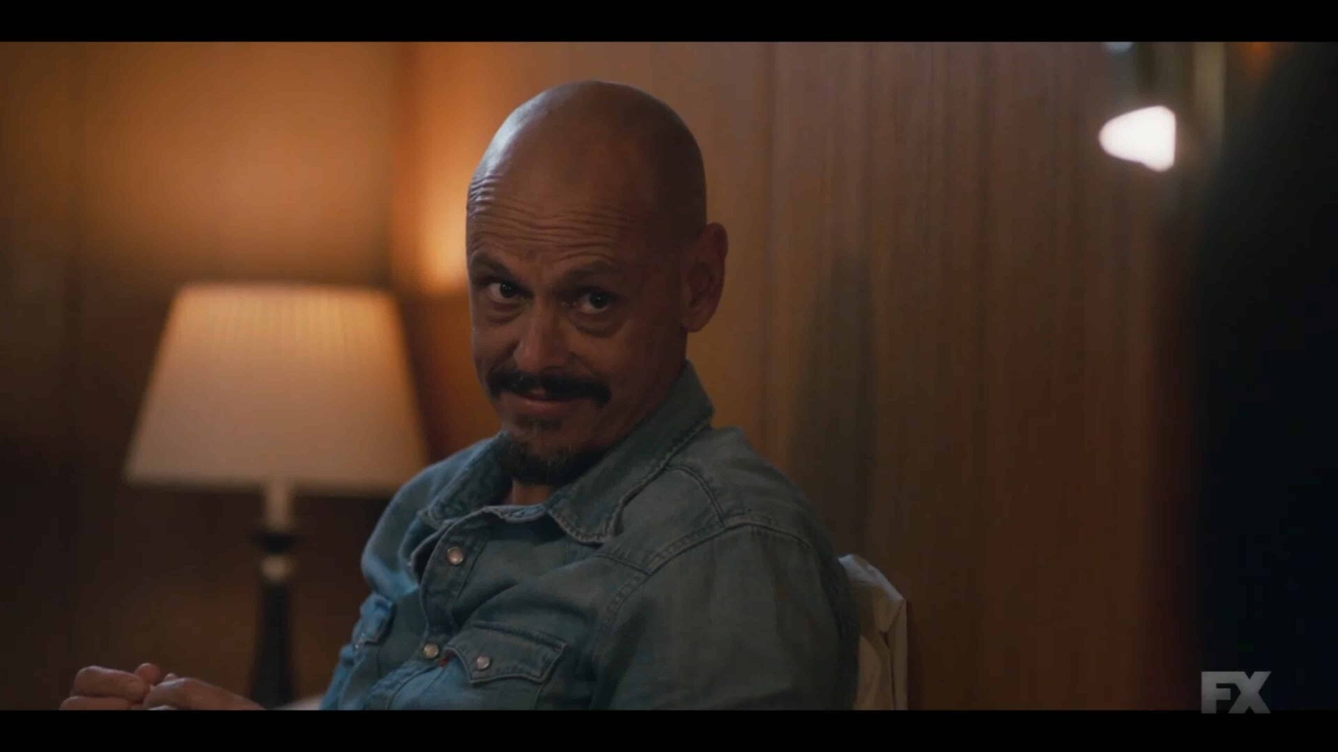 Ray looking over at Zoe, in their shared motel room