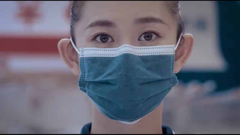 The Girl (Li Chao) taking the boy's temperature