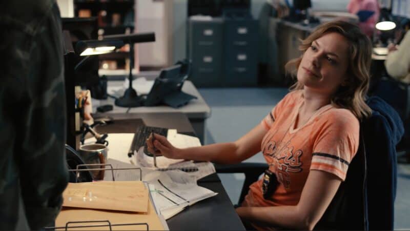 Leslie (Tonya Glanz) sitting at her desk