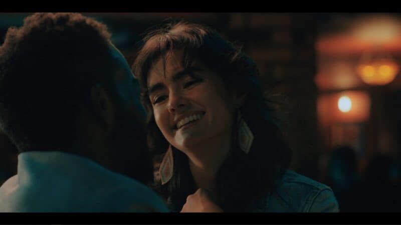 Paloma (Aline Mayagoitia) talking to Marcus at a bar