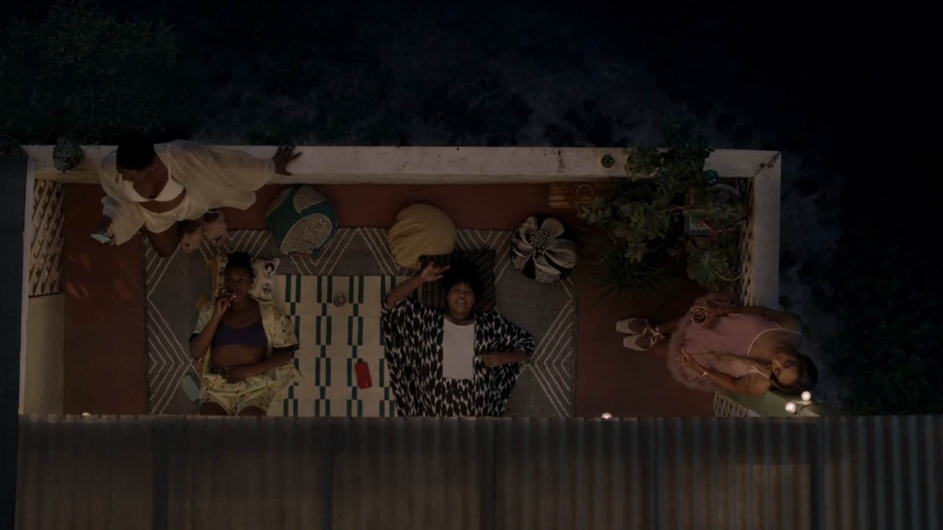 Molly, Issa, Kelli, and Tiffany smoking on Issa's balcony