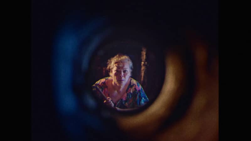 Leonor (Sheila Francisco) peering down a hole