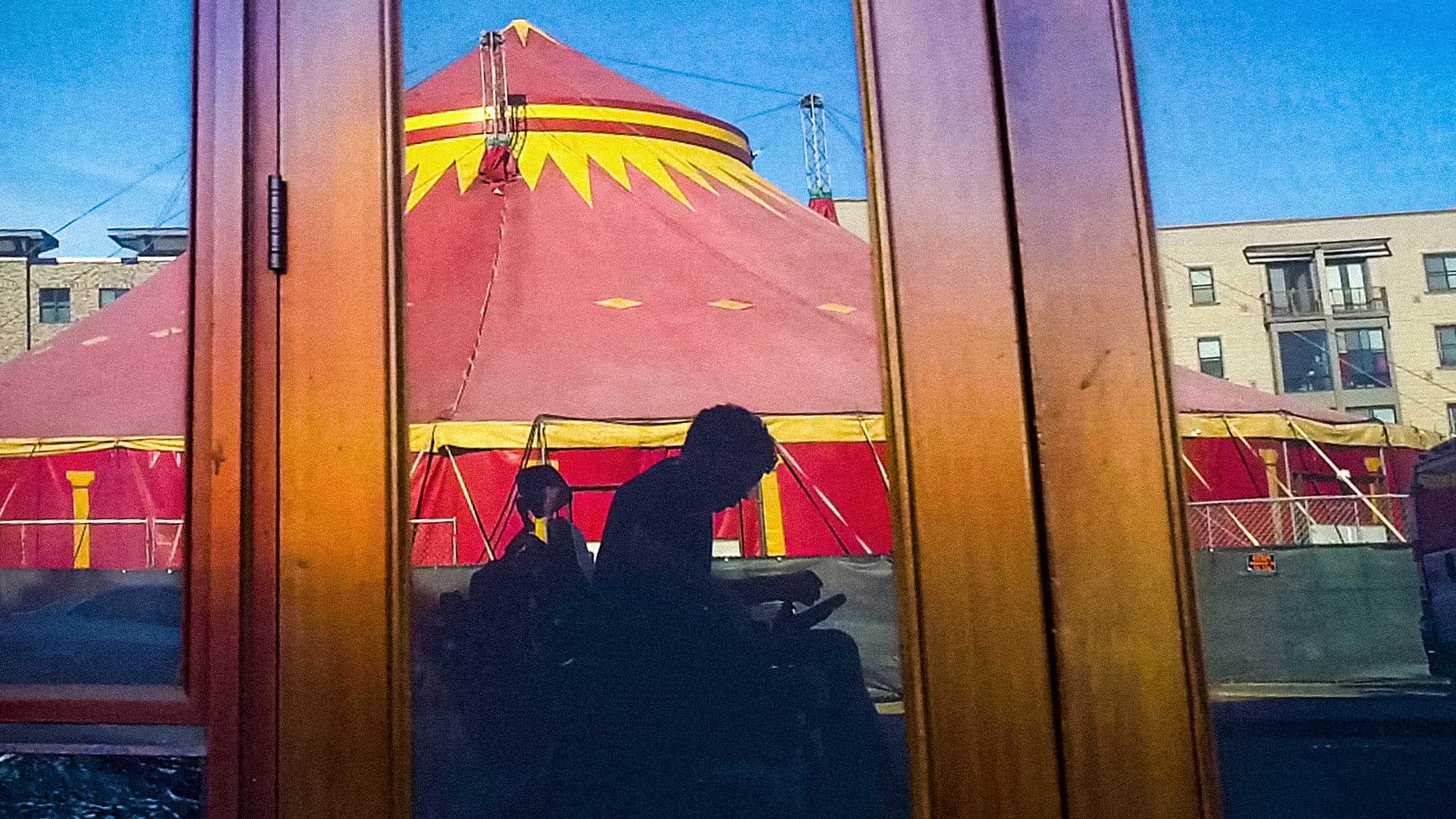 Reid's shadow as he passes a circus tent