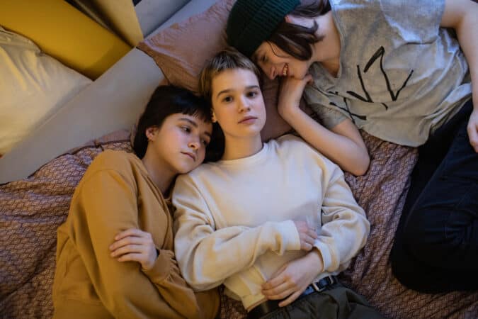 Yana (Yana Isaienko), Masha (Mariia Fedorchenko), and Senia (Arsenii Markov) in Masha's bed