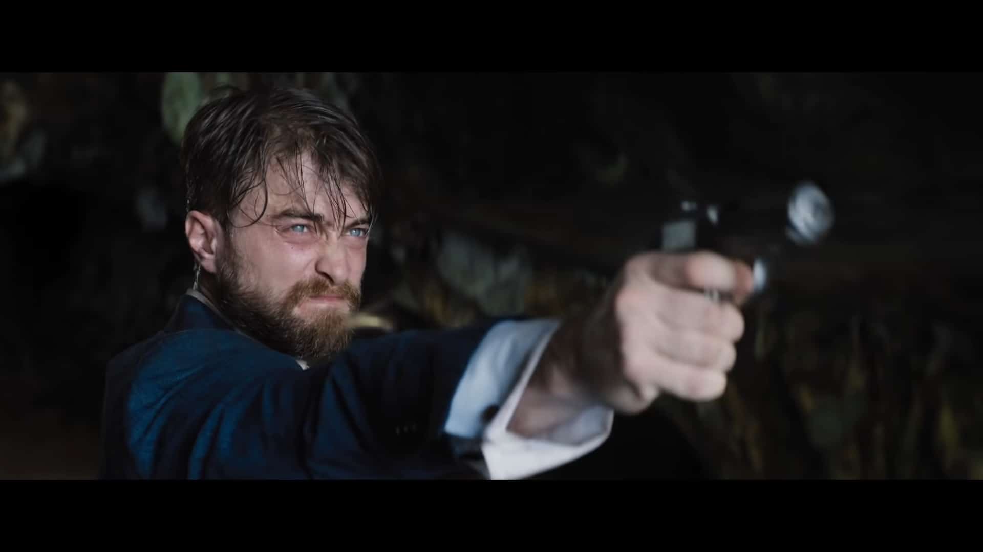 Abigail Fairfax (Daniel Radcliffe) with a gun in hand