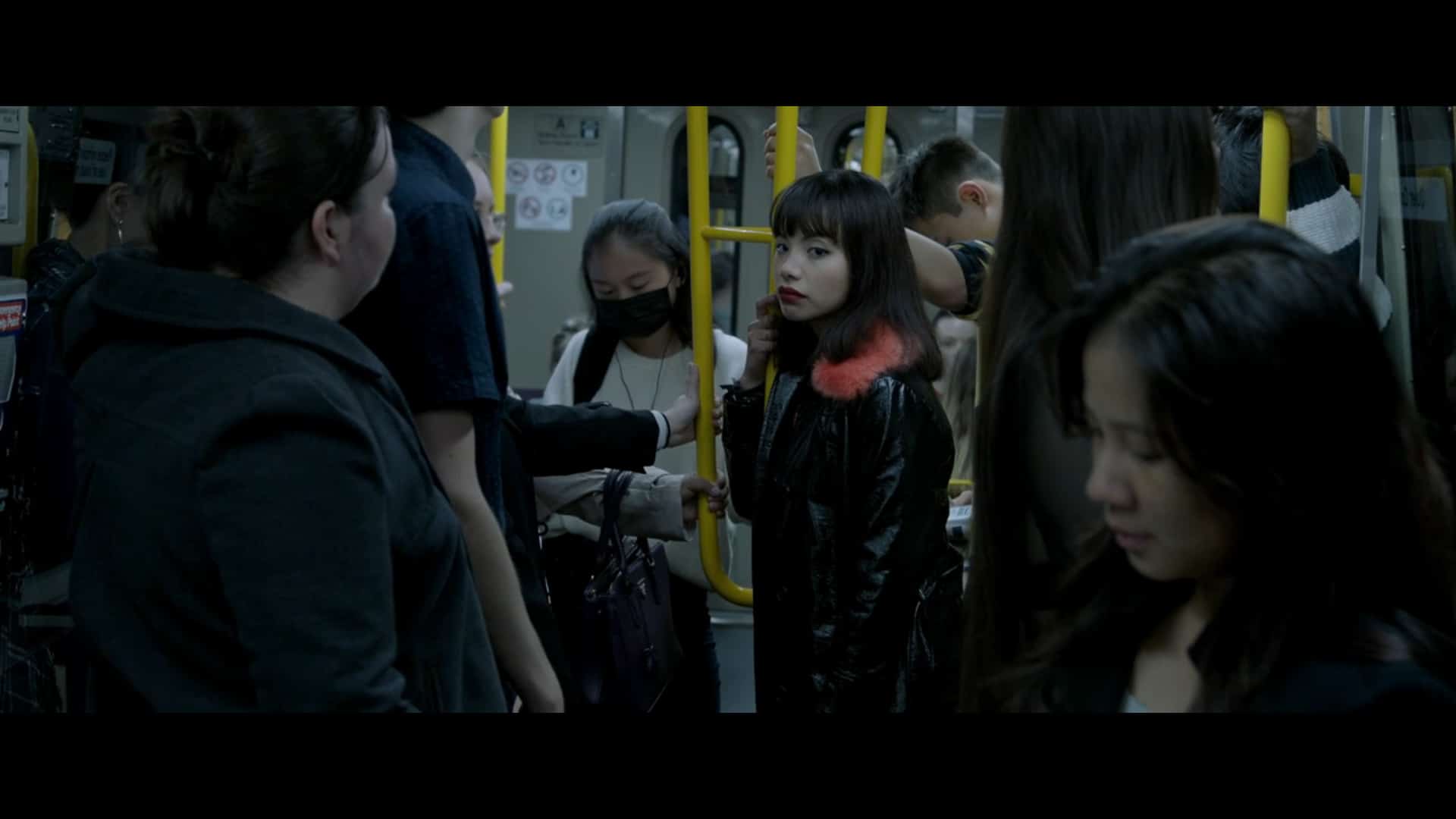 April (Jillian Nguyen) on the train, where Jack first saw her