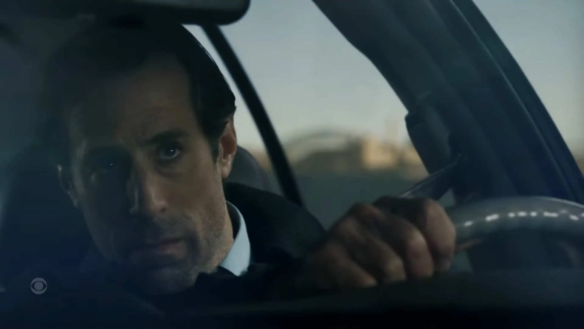 Bert (Josh Cooke) driving and avoiding the mafia's phone calls
