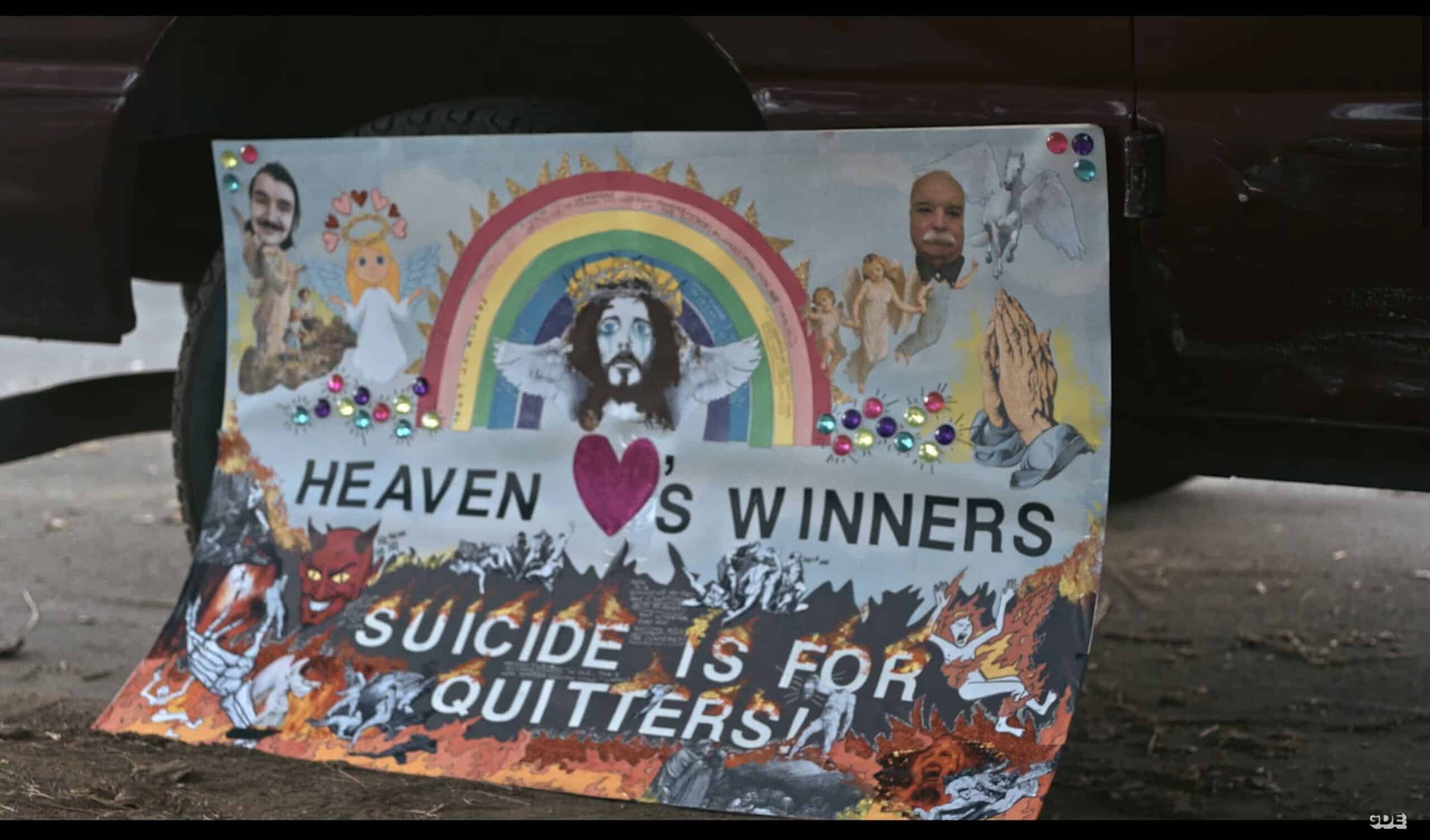 A sign saying: "Heaven love's winners. Suicide is for quitters!"