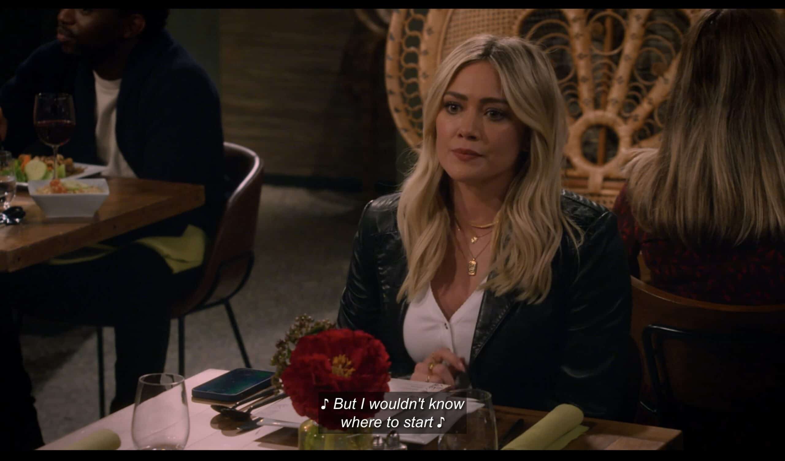 Sophie (Hillary Duff) waiting at a table in a restaurant