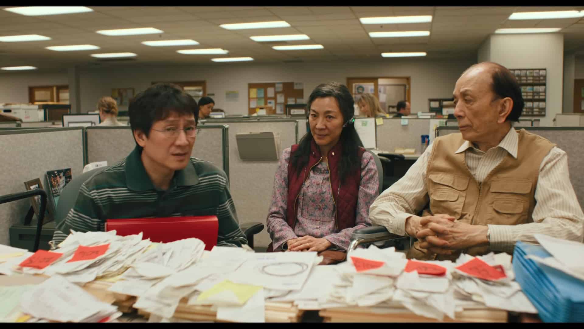 Waymond (Ke Huy Quan), Evelyn (Michelle Yeoh) and Gong Gong (James Hong) meeting with the IRS