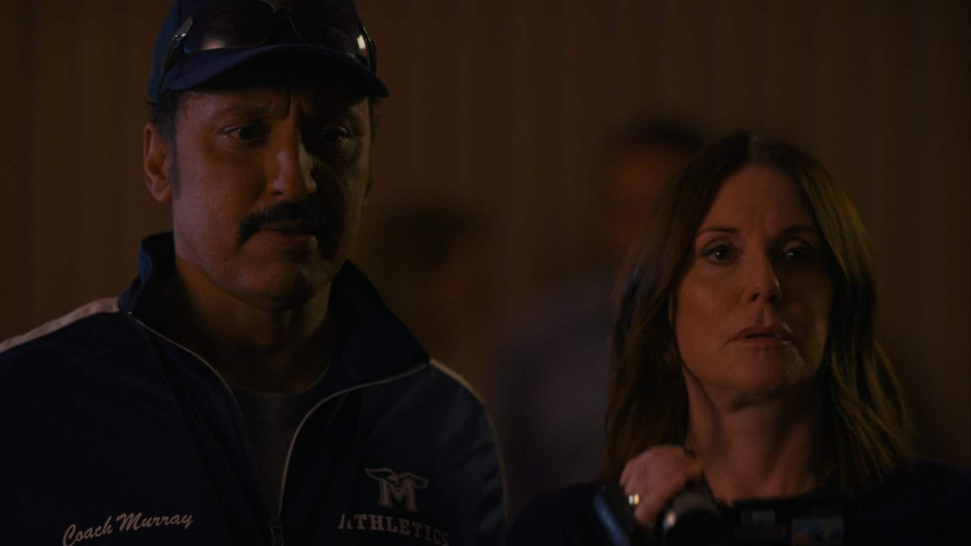 Coach Murray (Aasif Mandvi) and Angie watching Paige try to win AJ back