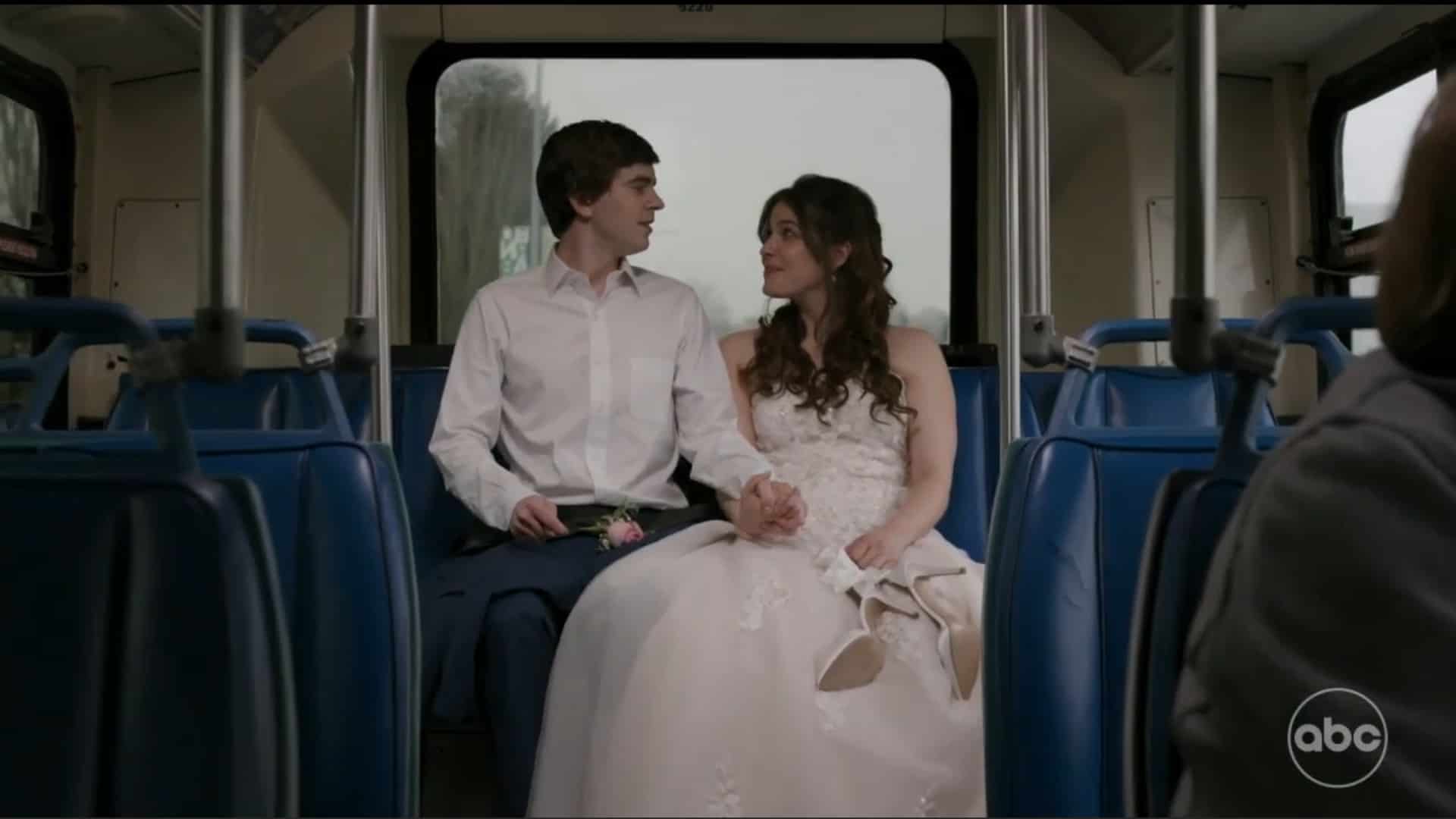 Shaun and Lea on a bus, in their wedding attire