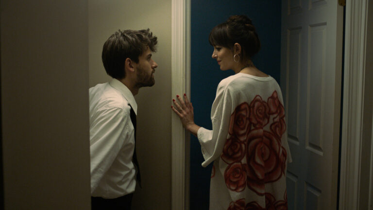 Andrew (Cooper Raiff) and Domino (Dakota Johnson) talking before she takes a shower