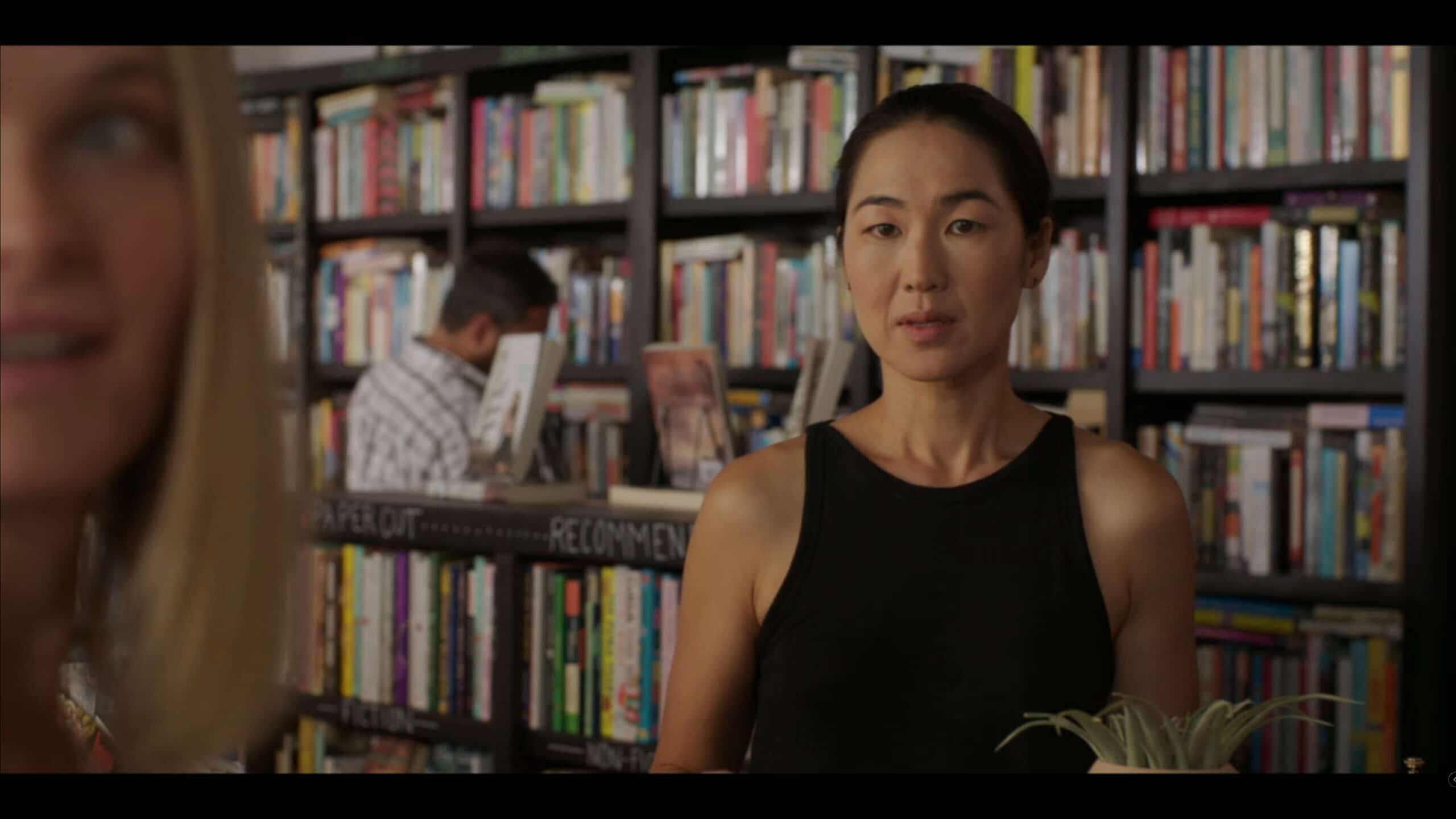 Laurel (Jackie Chung) meeting a fellow author at the bookstore, after making fun of him