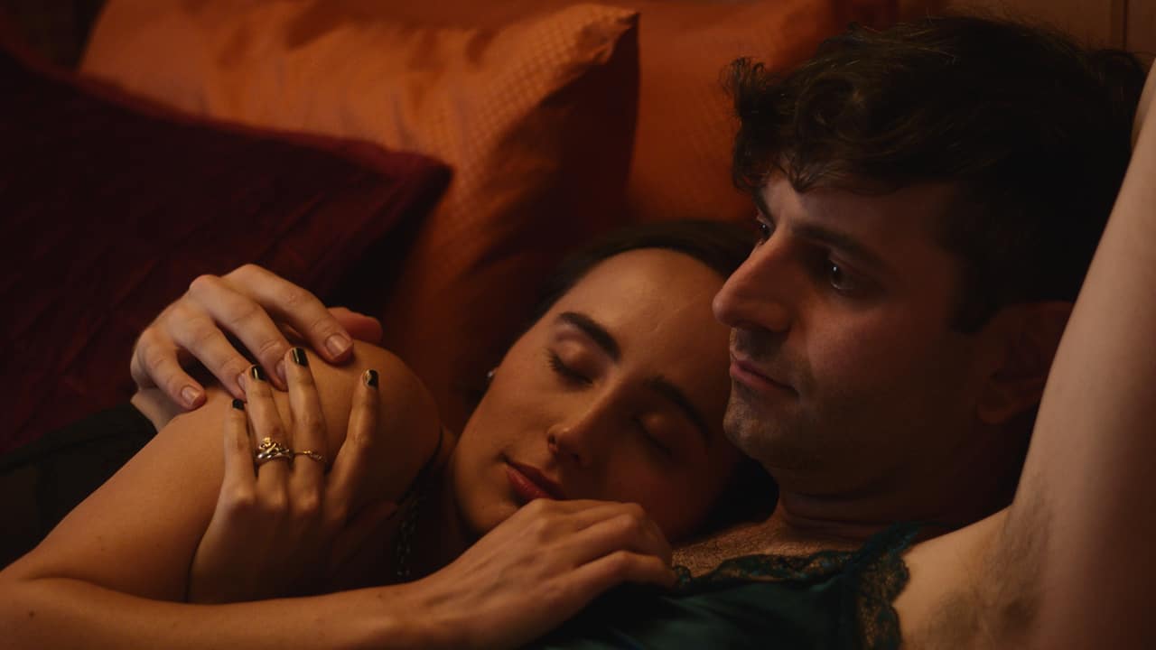 Mia (Sadie Scott) and Corey (Jacob Tobia) cuddling