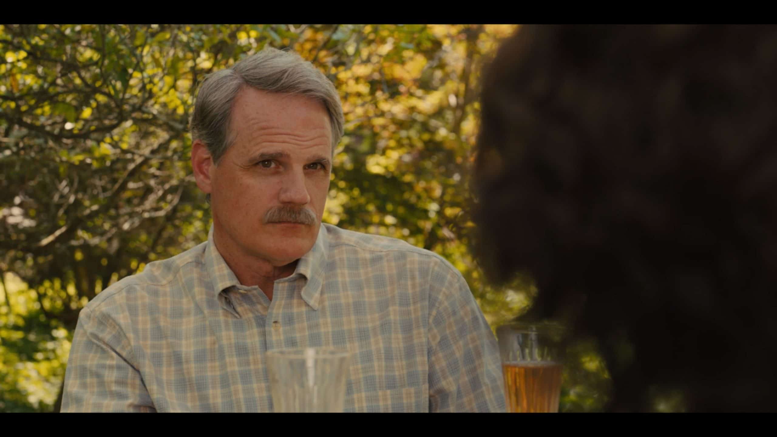 Phillip (Michael Park) talking to Henry at lunch