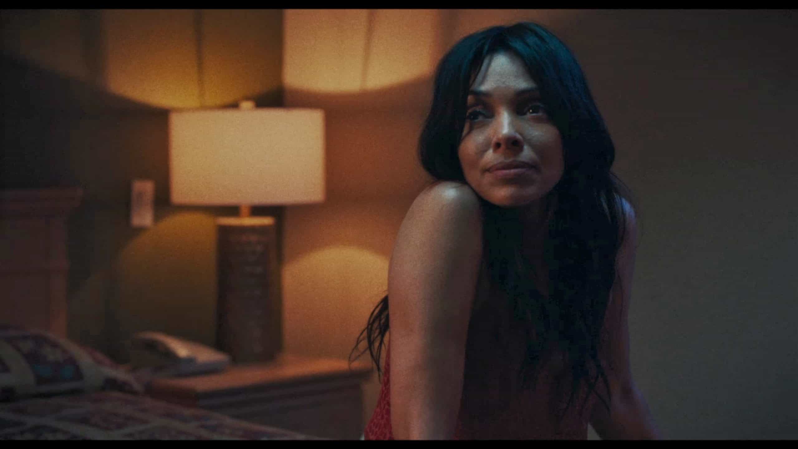 Anna (Tamara Taylor) in her motel room, talking to someone who she used to commonly sleep with