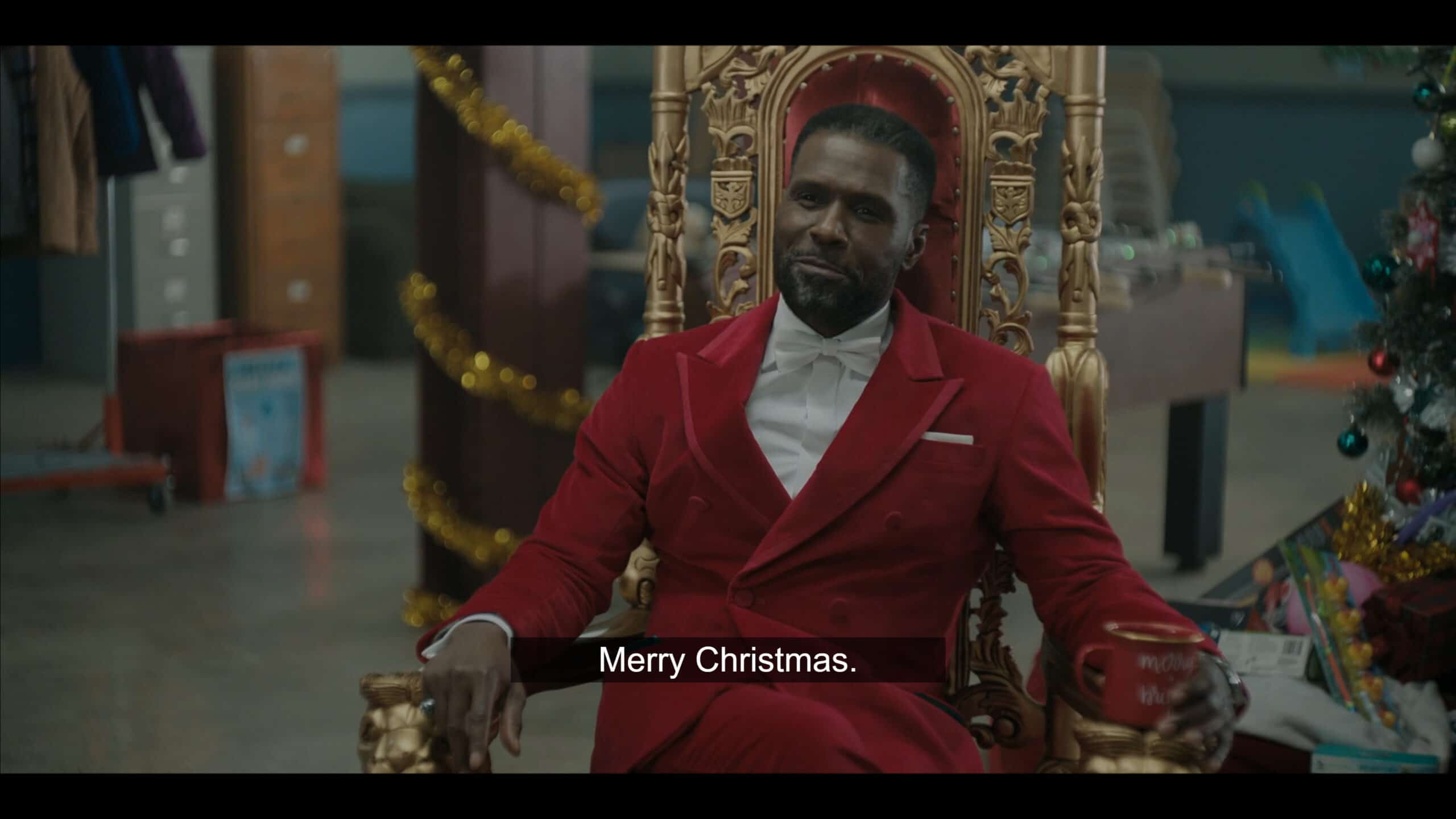 Otis aka Douda, sitting in a throne, wishing people Merry Christmas