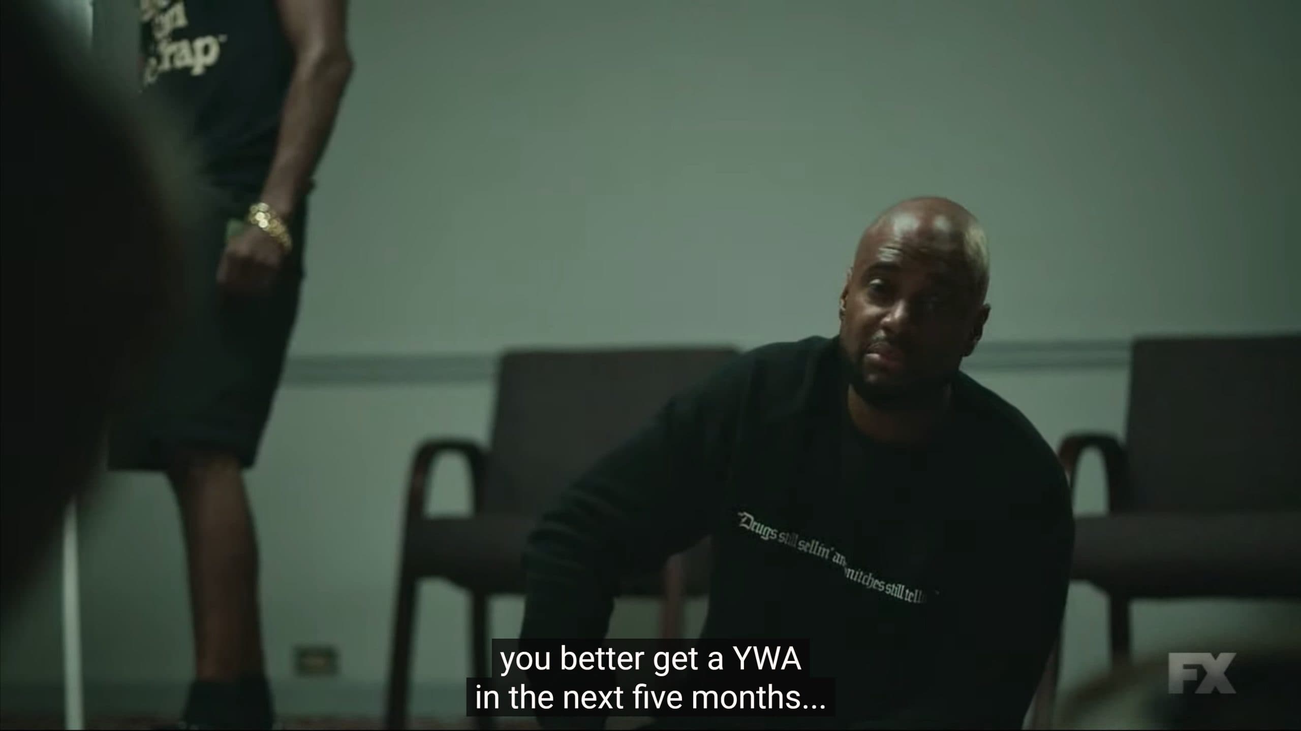 Buck (Charles Malik Whitfield) advising rappers in the room to invest in a YWA