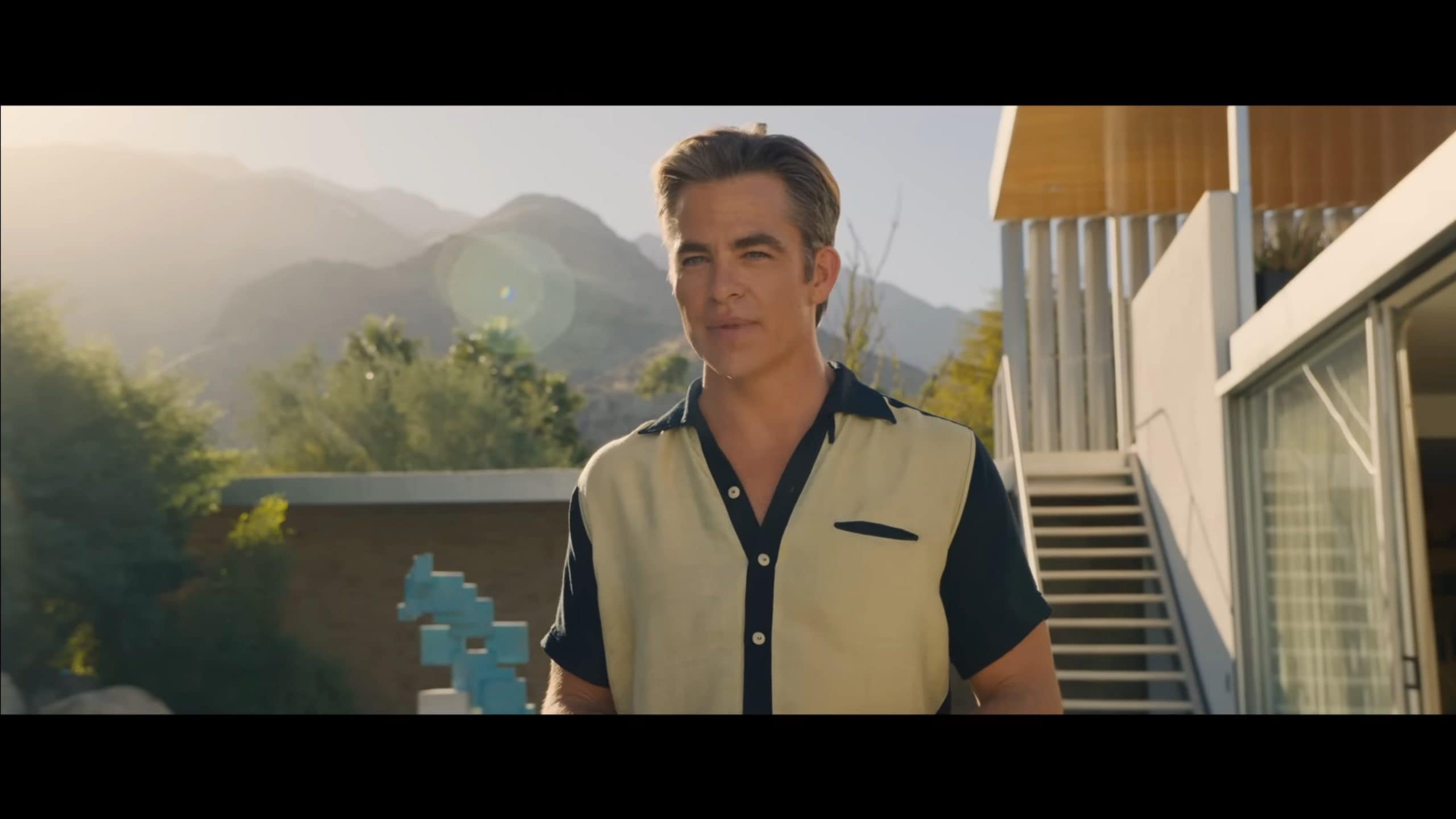 Frank (Chris Pine) addressing his guests at a pool party