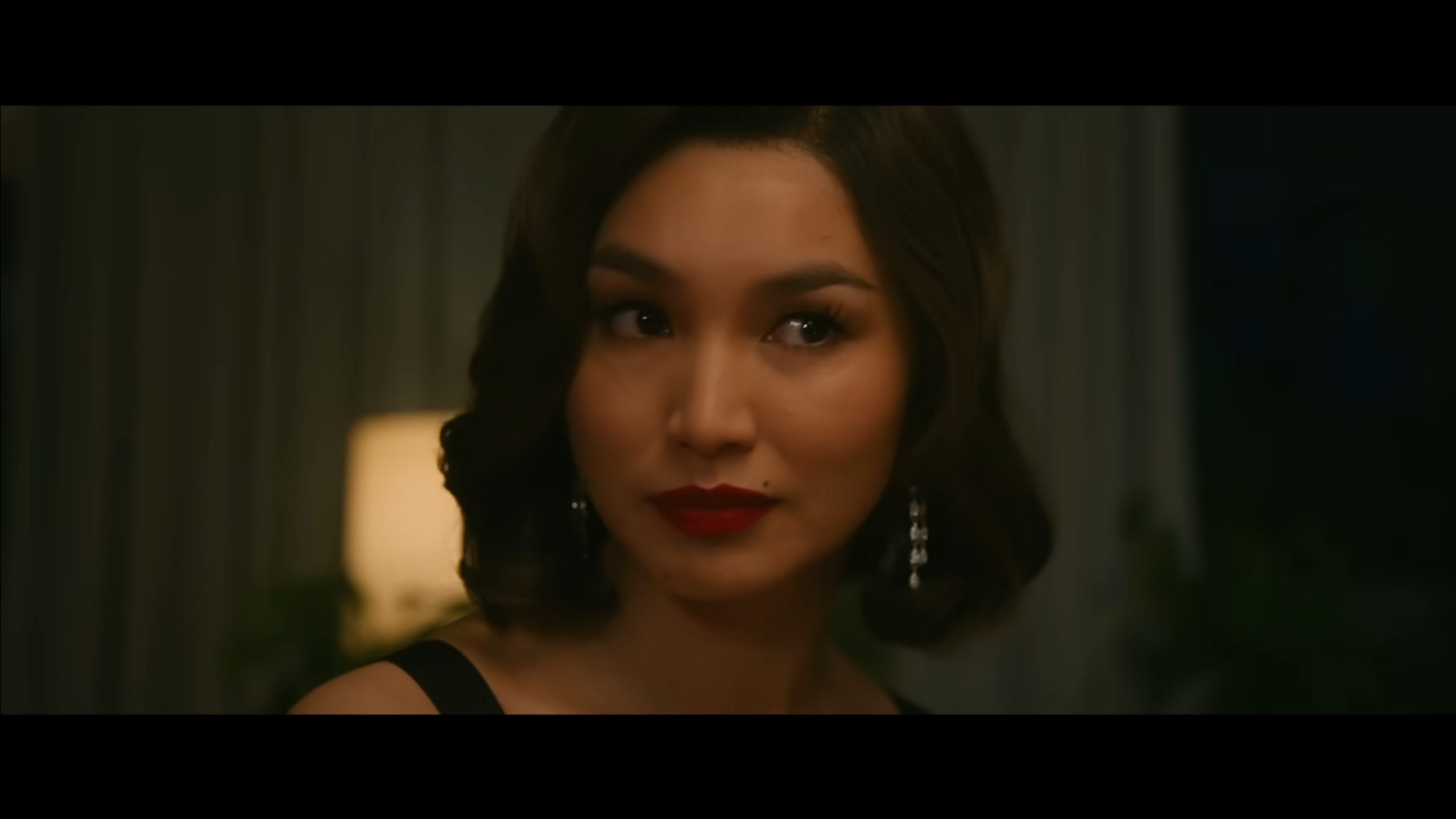 Shelley (Gemma Chan) at the dinner when Alice accuses Frank of heinous things in front of many people