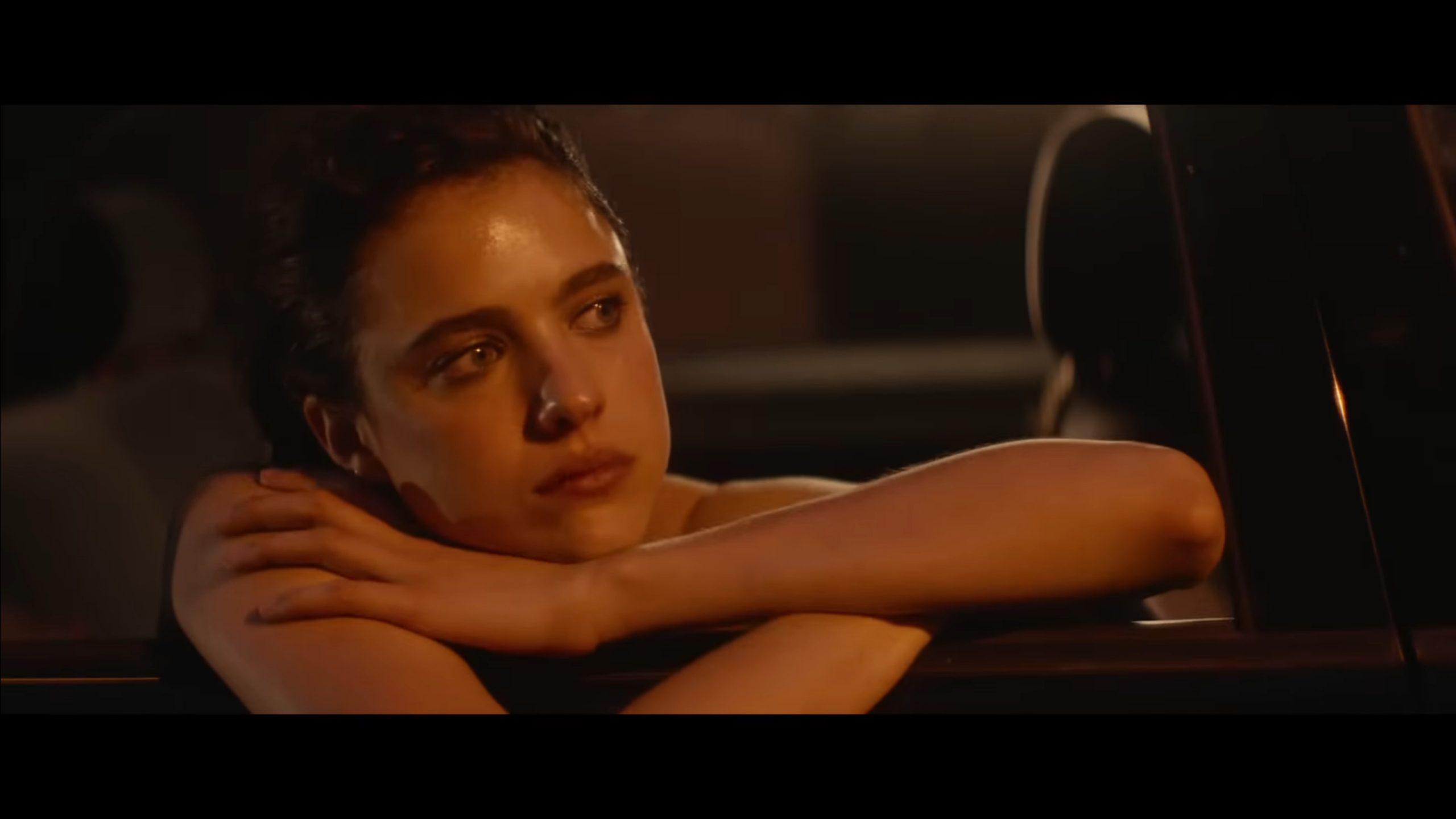 Trish (Margaret Qualley) in a cab, looking off into the distance