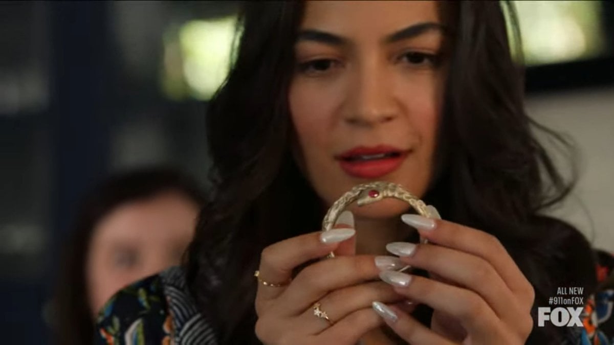 Felisa (Natalee Linez) holding what is originally thought to be a cursed bracelet