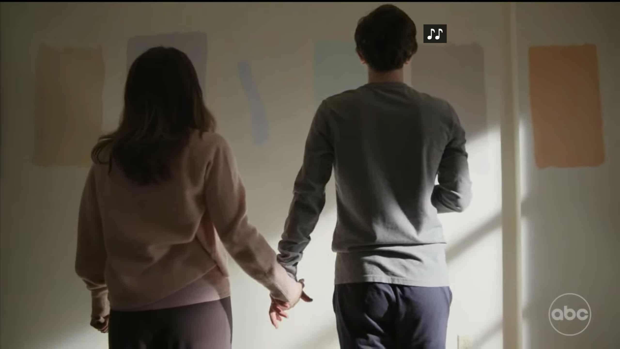 Lea and Shaun holding hands, looking at the wall of their son's bedroom