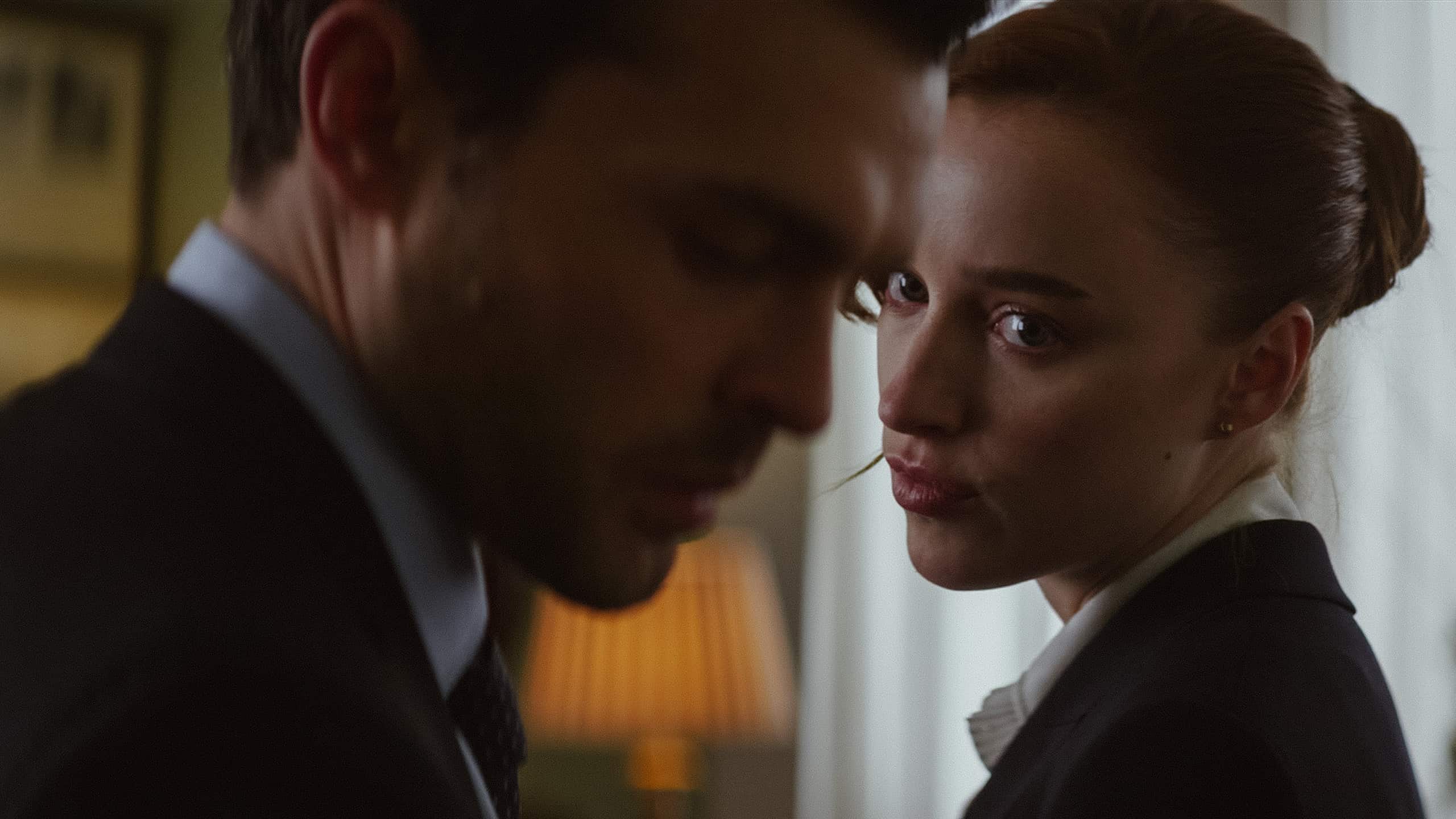 Emily (Phoebe Dynevor) looking over at Luke (Alden Ehrenreich)