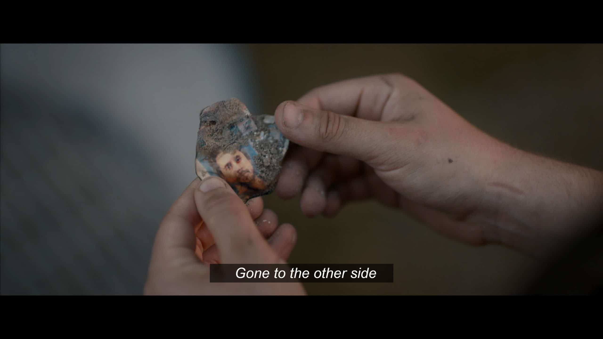 Callie (Sarah Desjardins) holding Adam's burnt identification