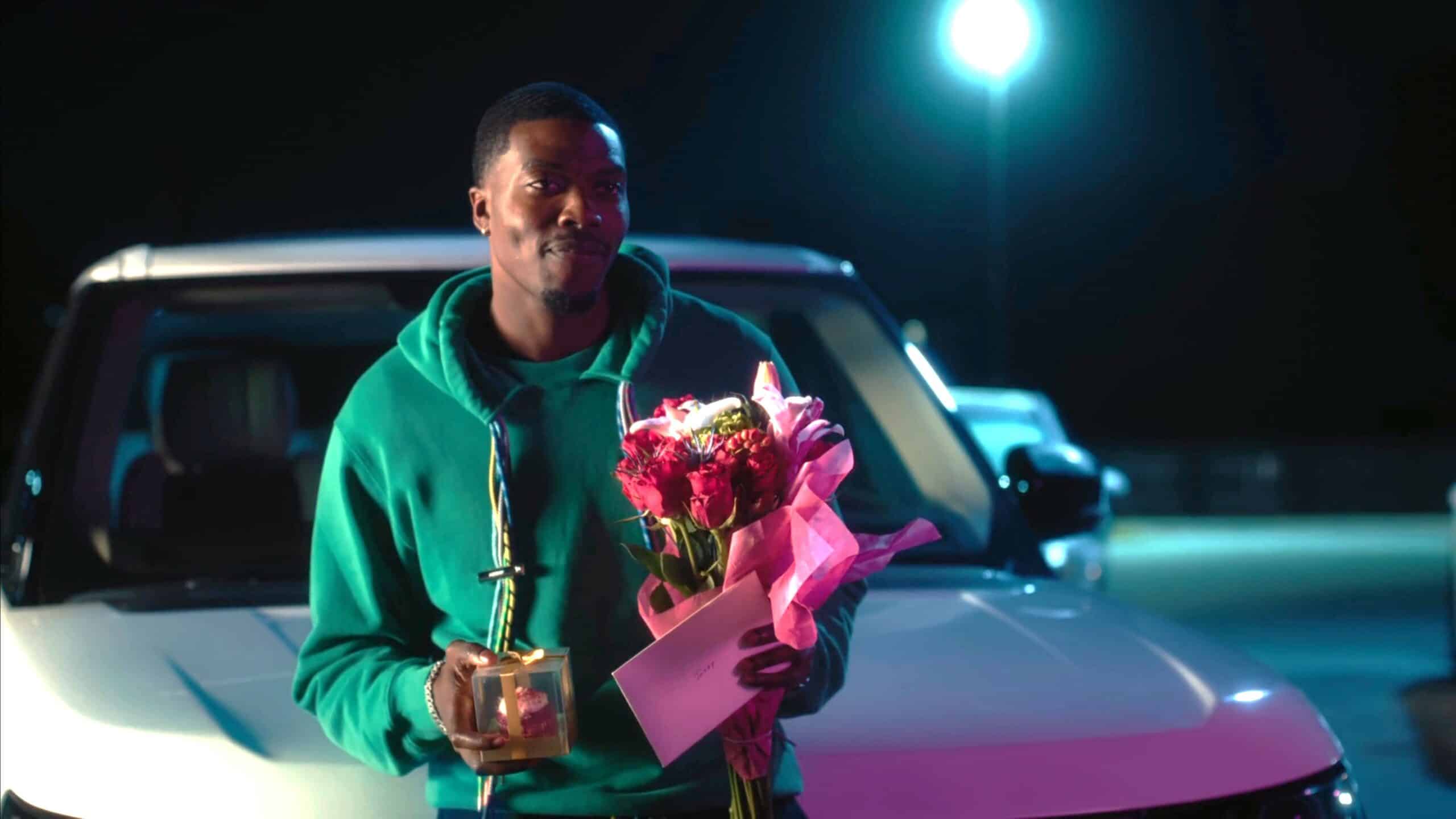 Wayne (Duby Maduegbunam) with a cupcake and flowers