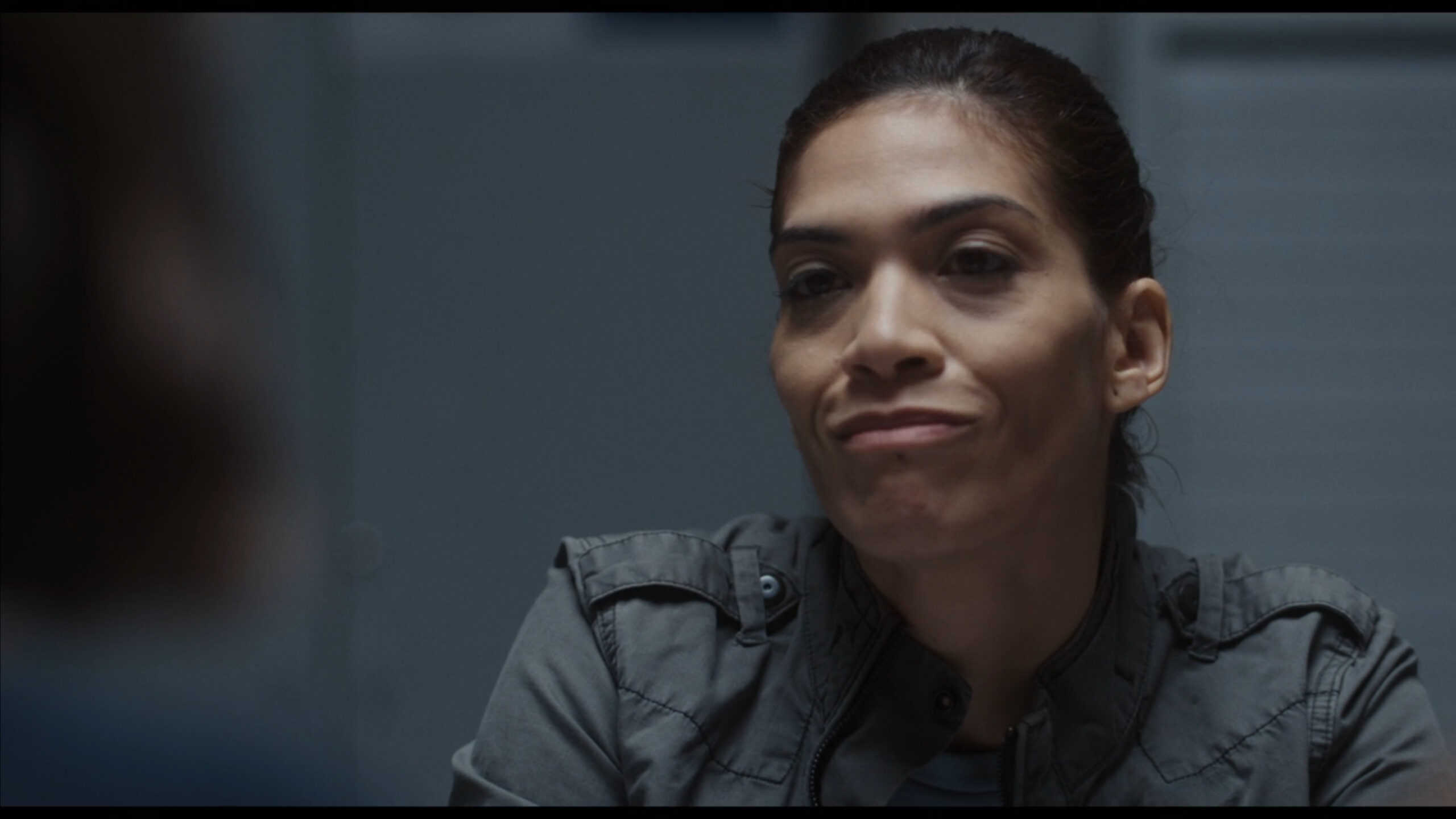 Agent Vasquez (Laura Gomez) doing a interrogation
